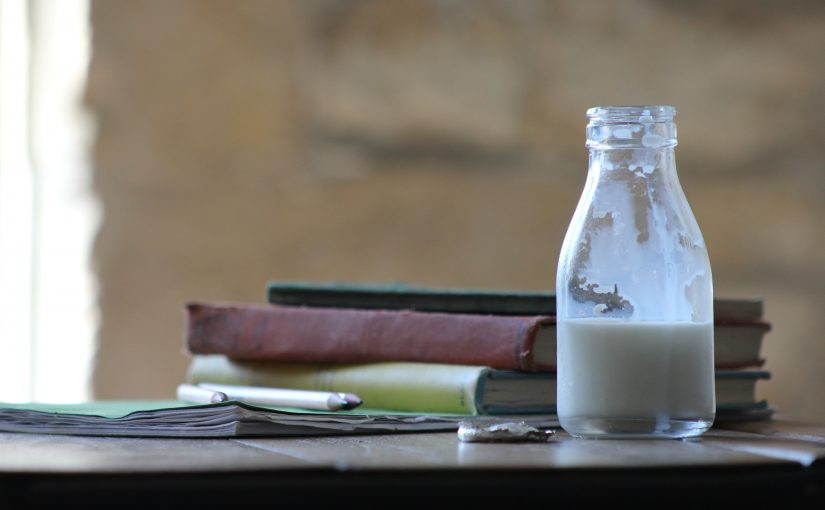 milk bottle on table dairy for empaths article by erin moore centered one