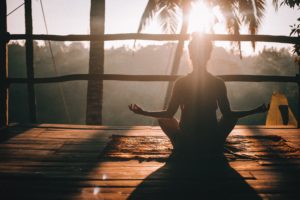 Relaxing scene of woman doing yoga in Centered One blog article about how to protect your energy as an empath.