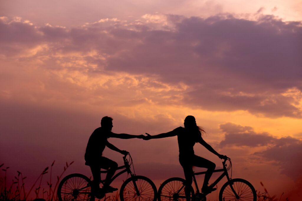 couple biking reaching codependency