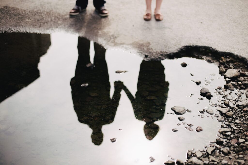 couple in puddle mirror in blog by erin moore, centered one about emotional withdrawal in relationships