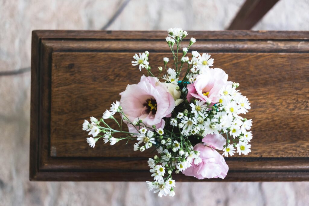 pink flowers on coffin in blog about grief flowers by erin moore centered one