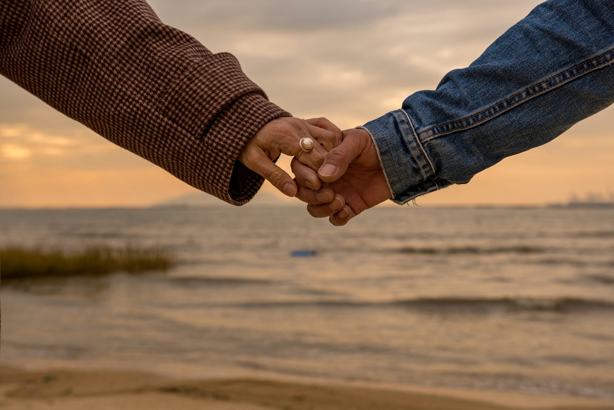 couple holding hands in blog about couples therapy for trust issues by erin moore centered one