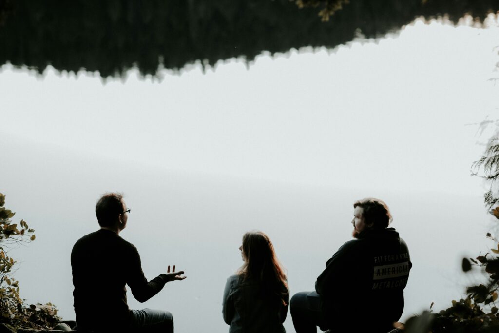 people talking by the water in blog by erin moore centered one about psychology of cult leaders