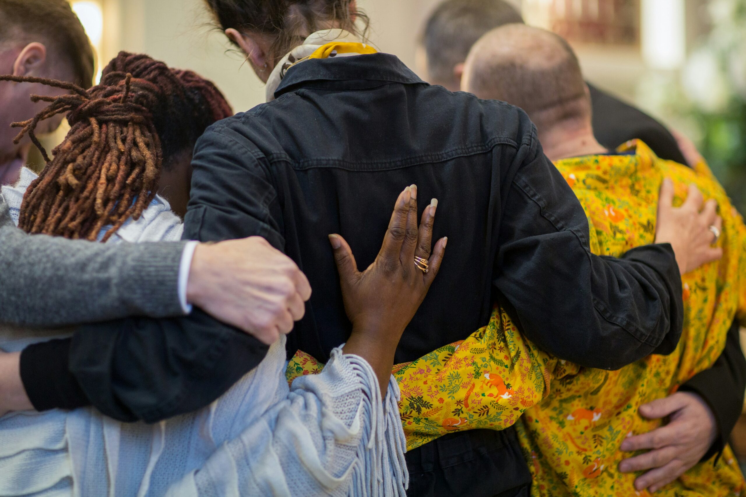 group hugging in blog about unhealthy coping for grief by erin moore centered one