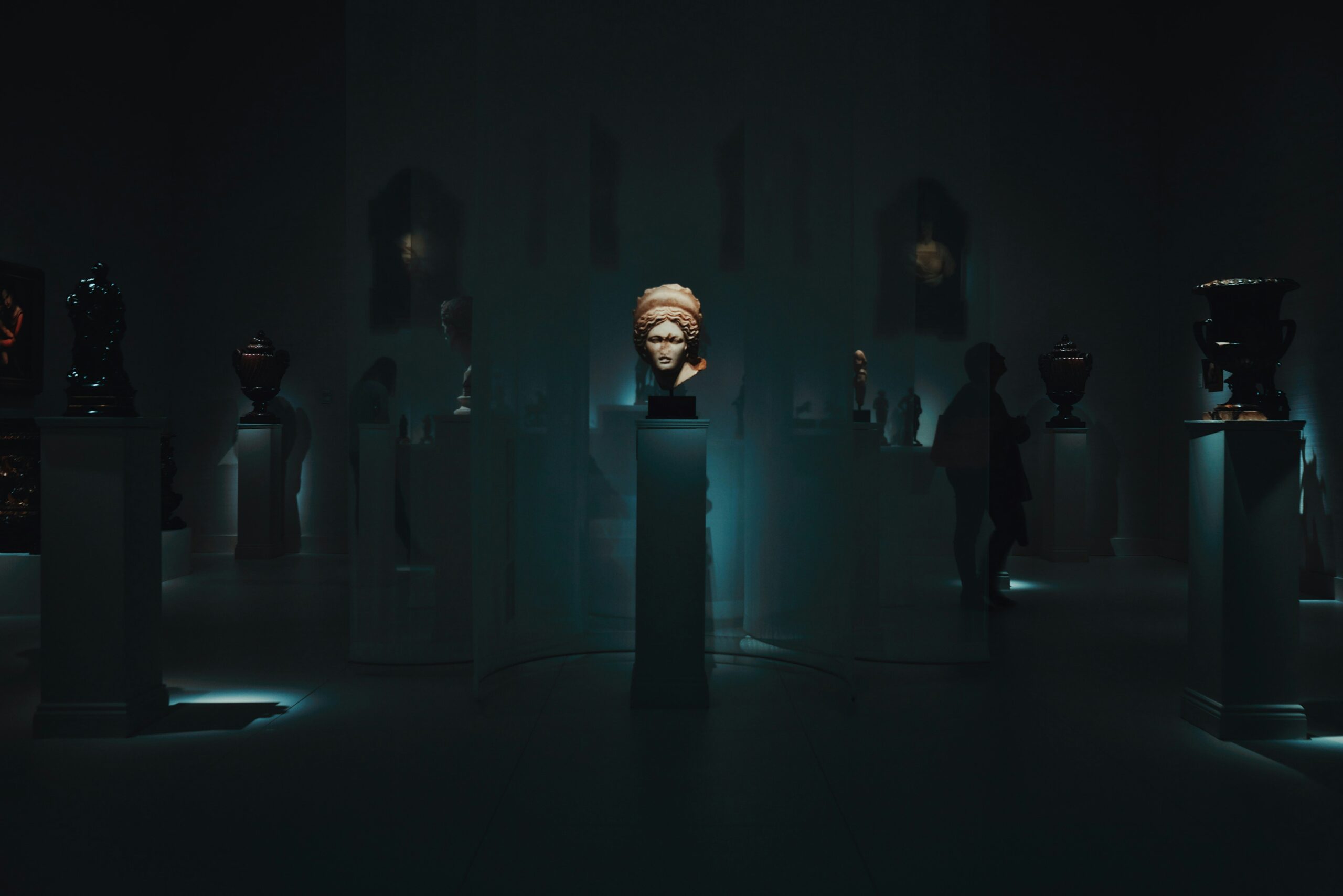 figurehead in dark surrounded by people in blog by erin moore centered one about cult leader psychology