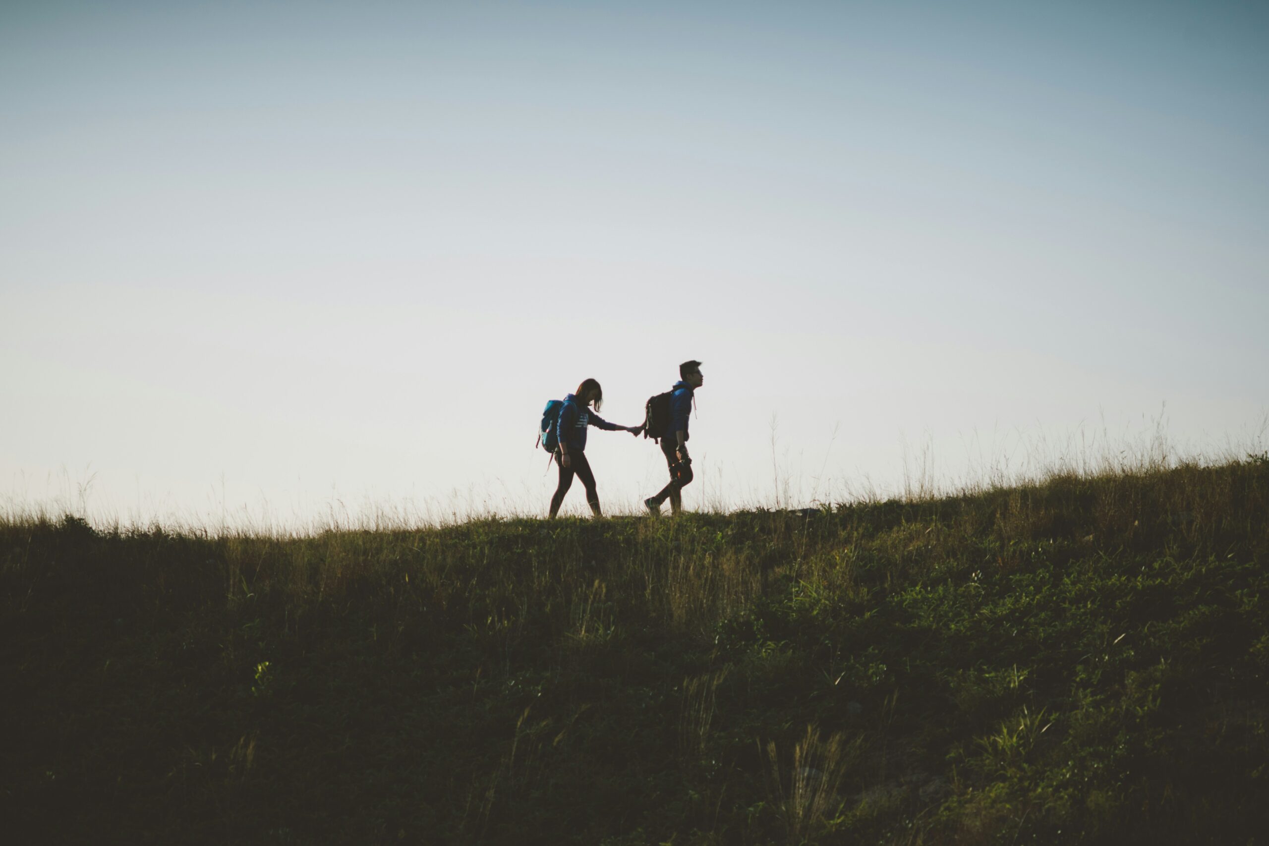 one person walking in front of another on a hill in blog about empath leaves a narcissist by erin moore centered one