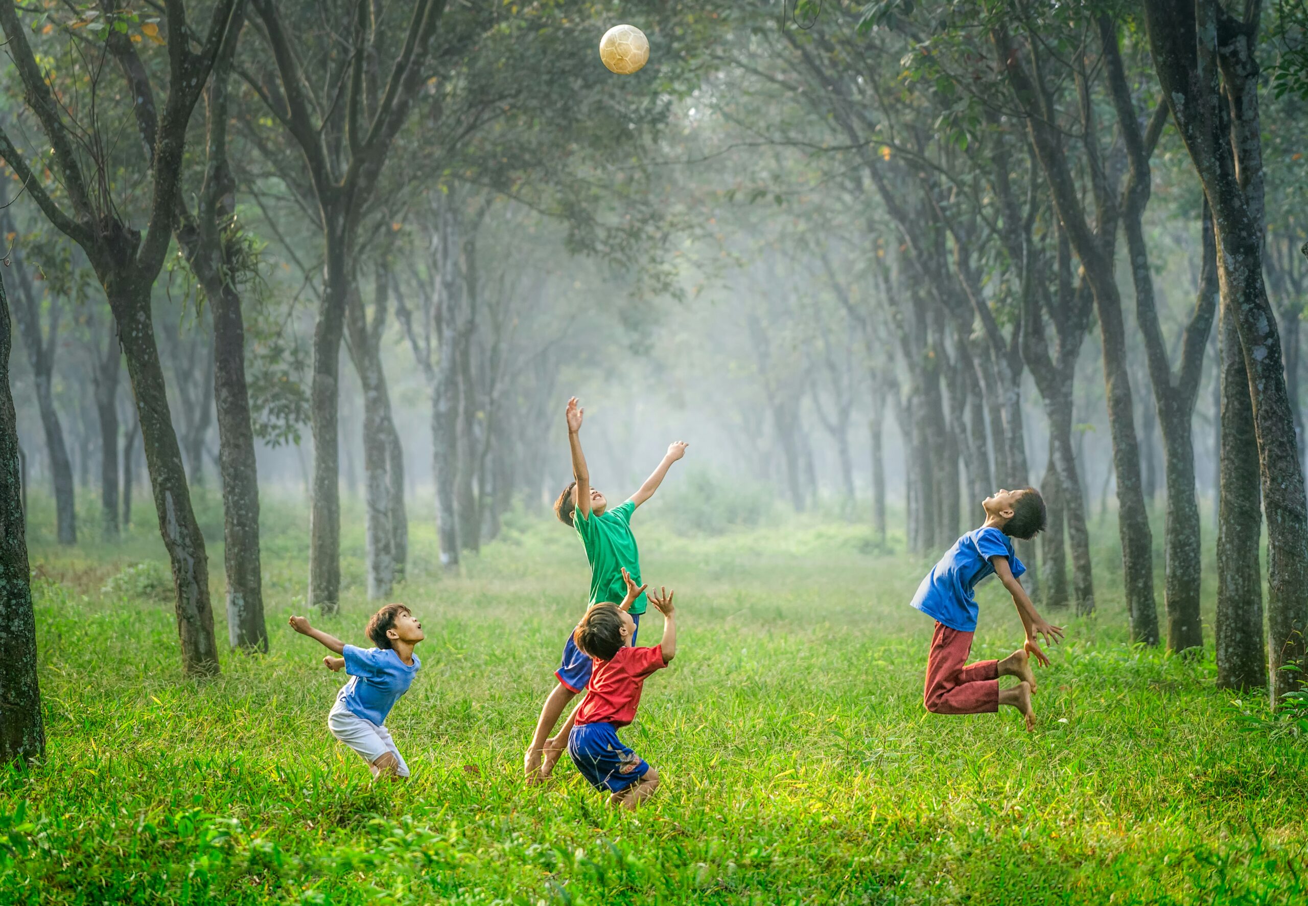 happy children playing ball in field in blog about inner child healing exercises by erin moore centered one