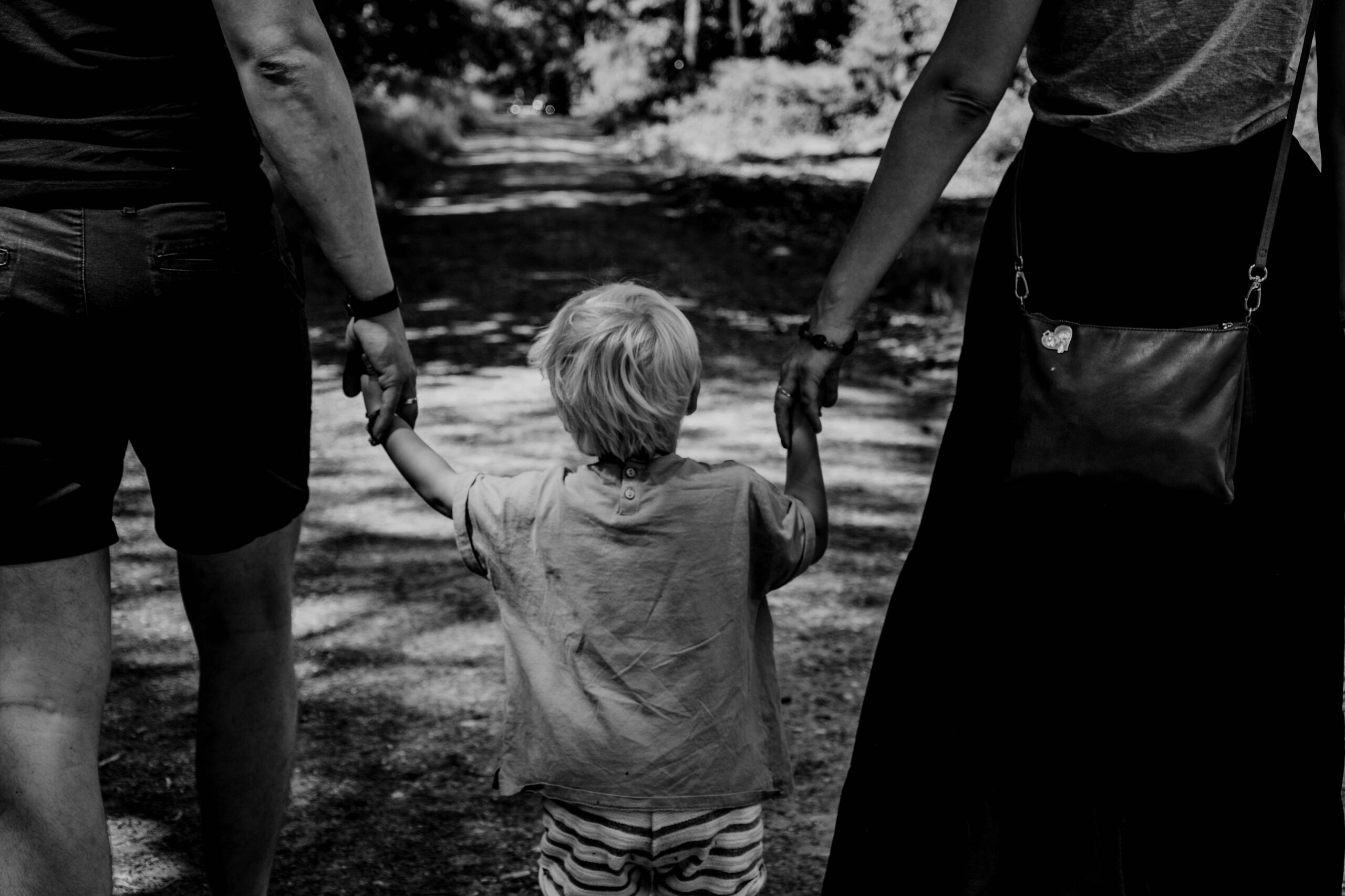young son walking with parents in blog about how to deal with manipulative parents by erin moore centered one