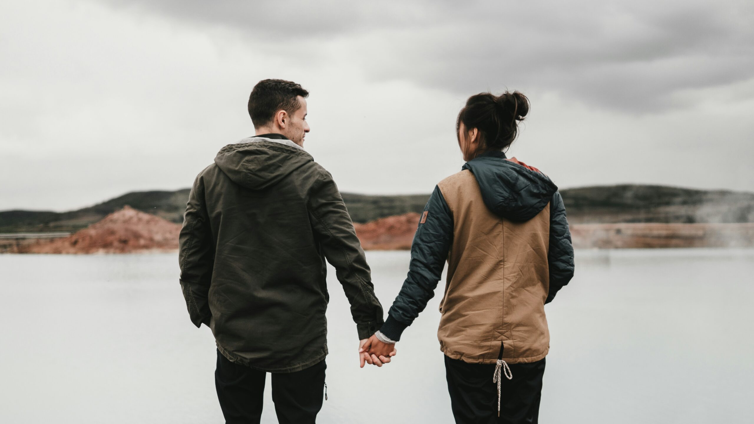 couple holding hands in blog about gaslighting by erin moore centered one