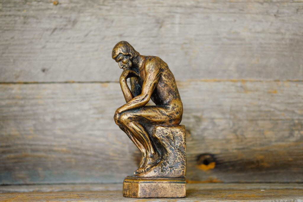 gold thinker statue in blog about how to stop catastrophic thinking by erin moore centered one