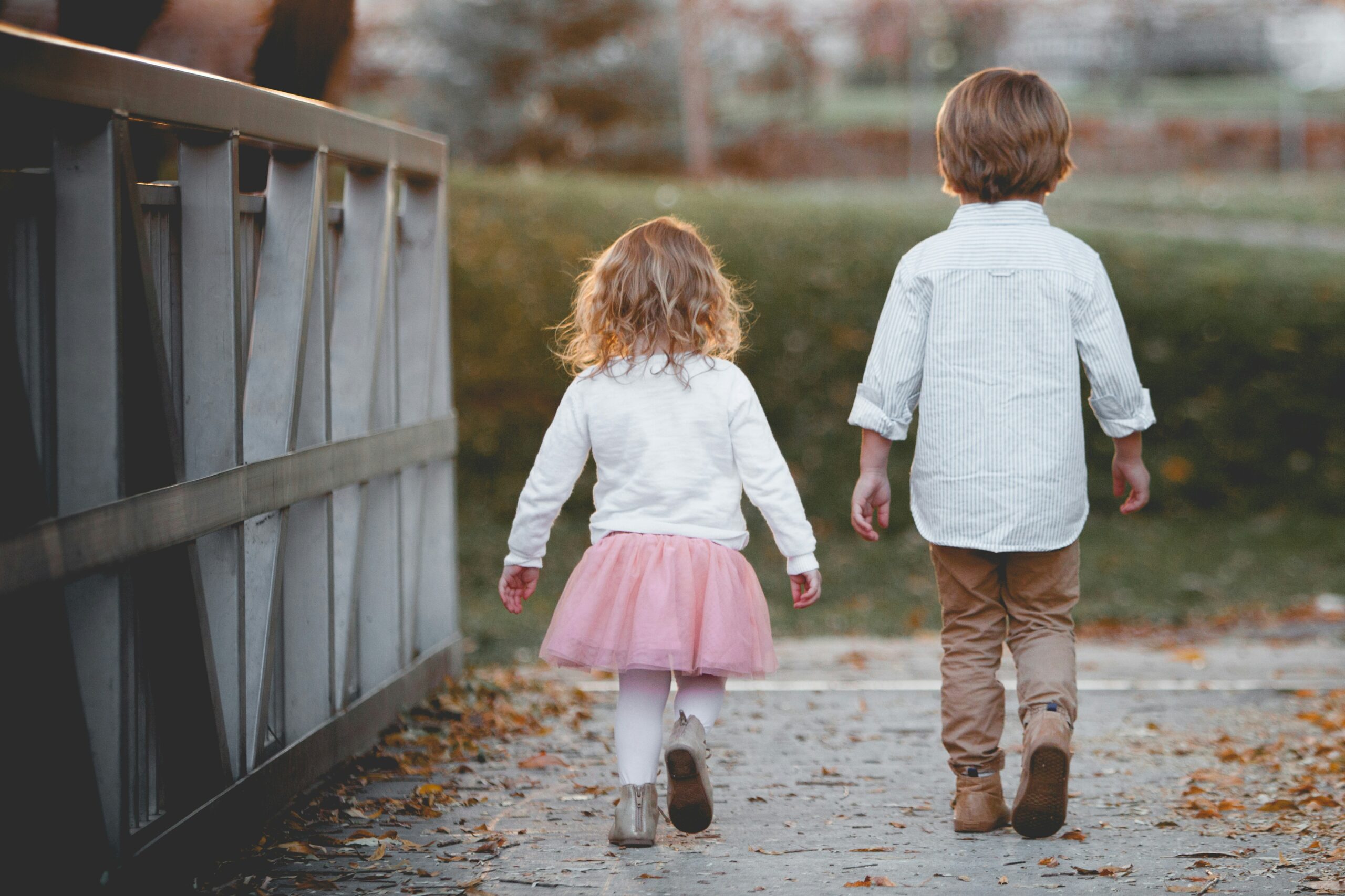 brother and sister children walking together in blog about how to deal with sibling rivalry by erin moore centered one