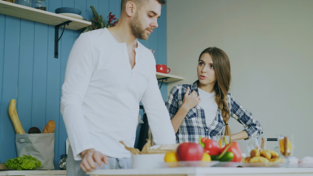couple arguing in kitchen in blog about conflict avoidance in relationships by erin moore centered one