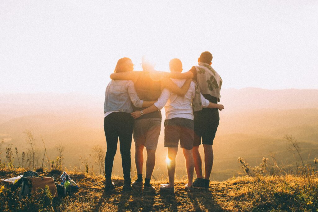 friends arm in arm at sunrise in blog about putting someone on a pedestal by erin moore centered one